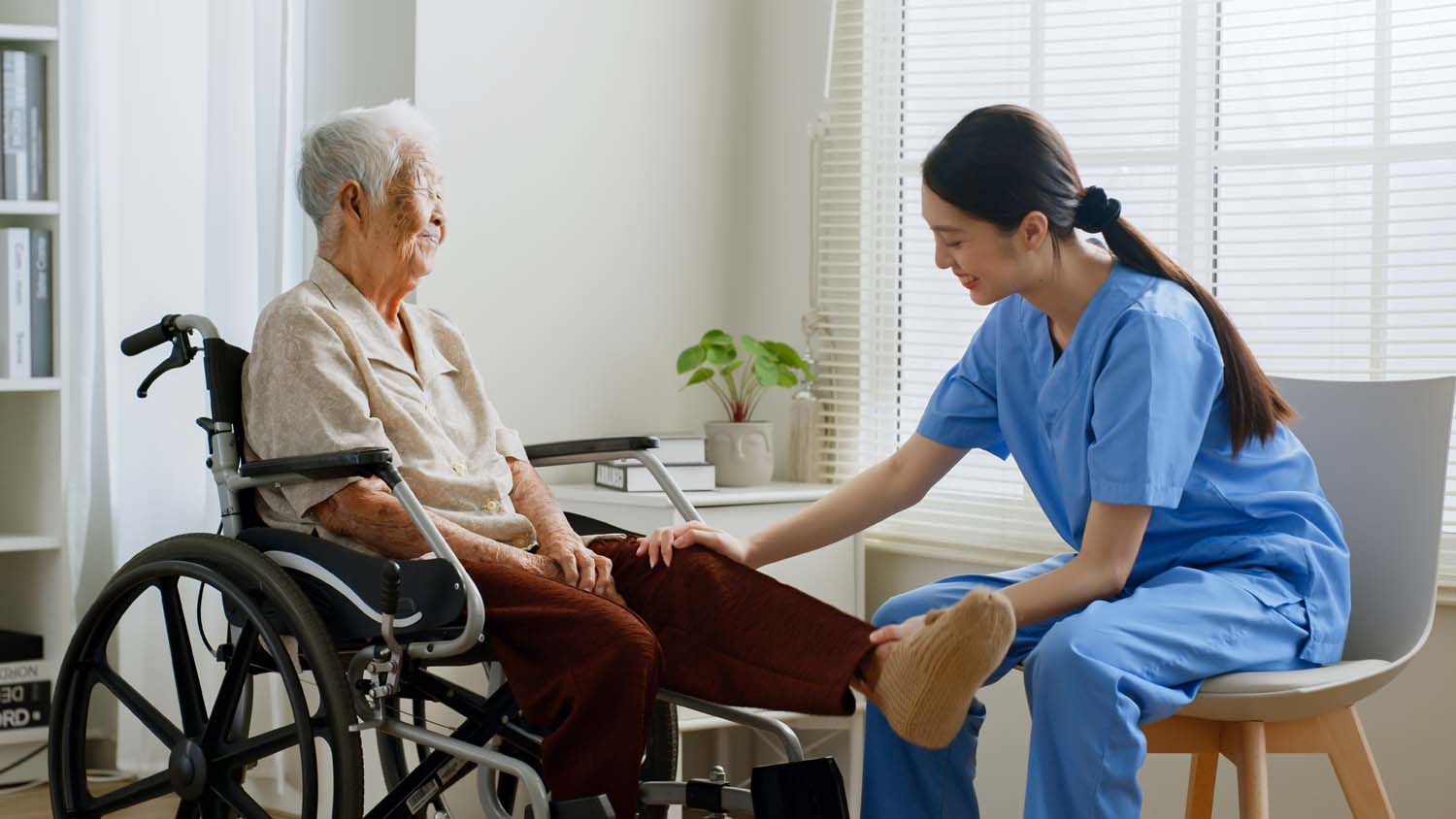 Young Asian woman nurse, caregiver assist a senior Asian woman t